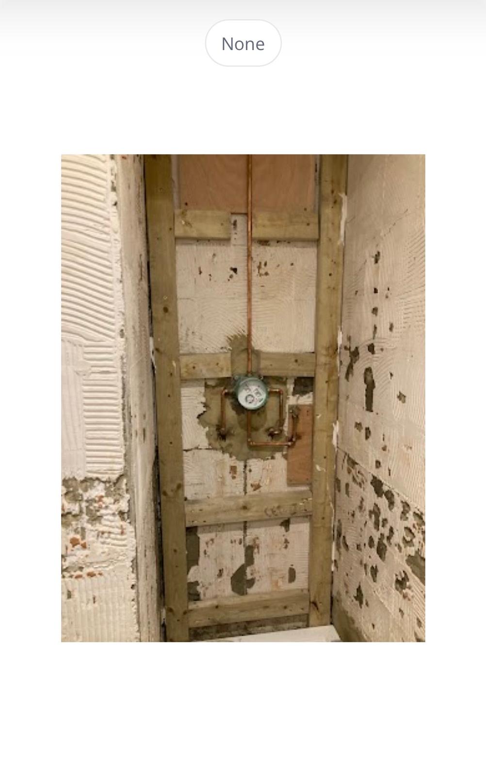 Shower wall stripped back before installation